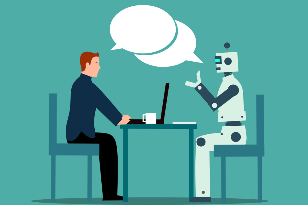 person talking to a robot at a desk as an example of using automation