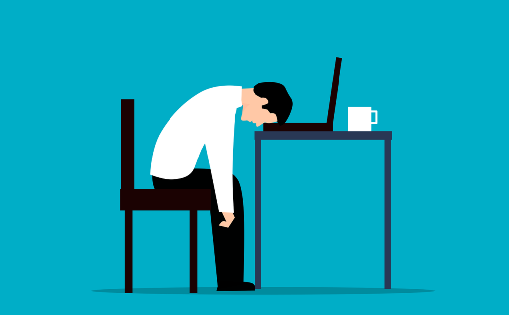 illustration of person slumped over a desk suffering with stress